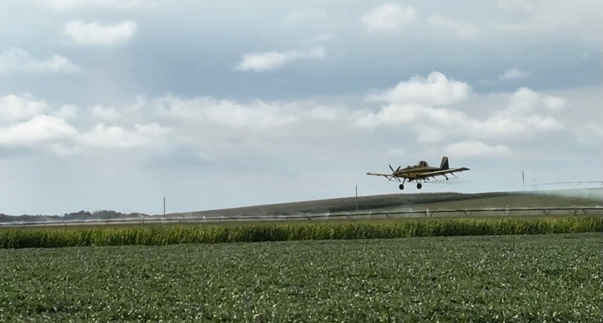 Aerial spraying over Midwest farmland